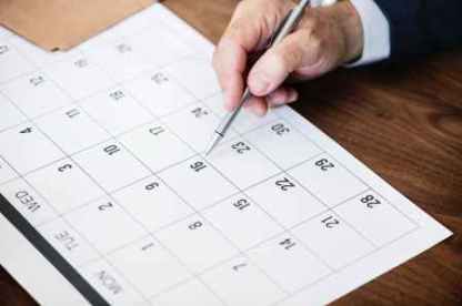 Pen points at calendar to show importance of keeping a date, in this case deadline for Open Enrollment is Sept. 28