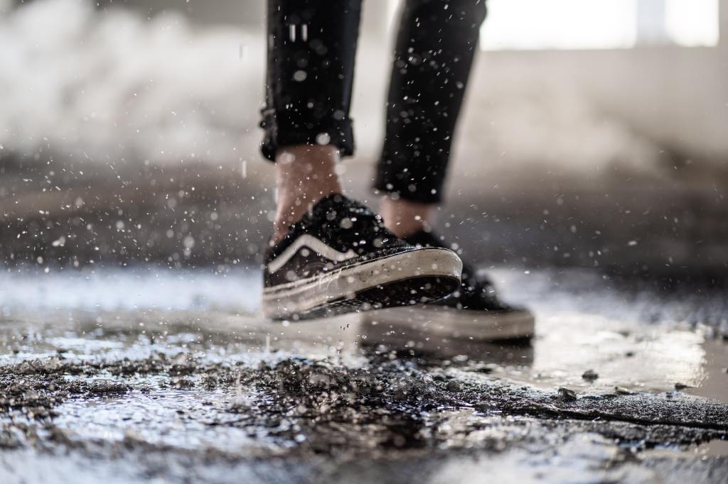 Close up of feet walking in the rain
