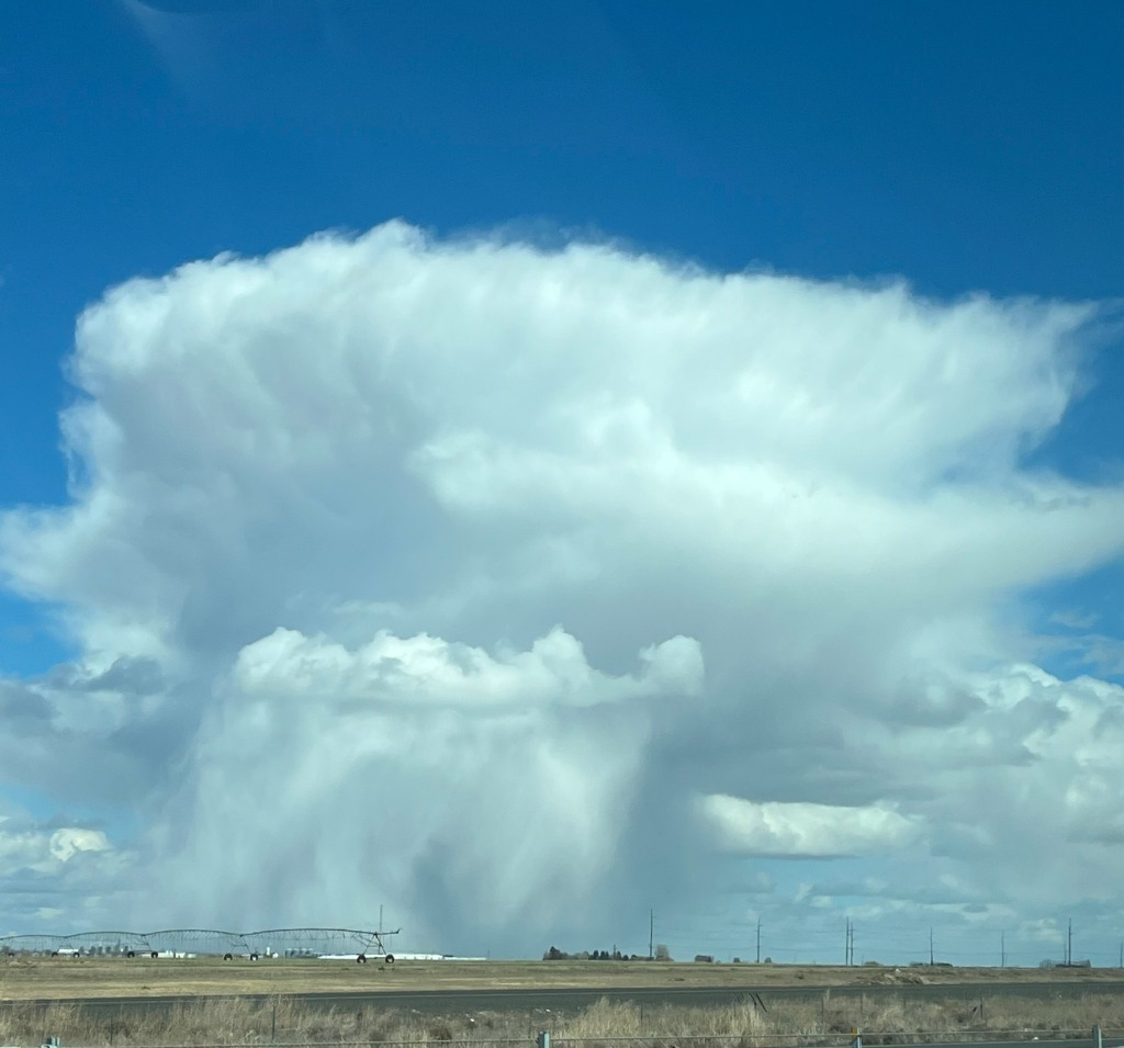 Large puffy white clouds over Hiawatha Road in Moses Lake